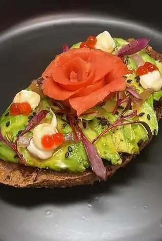 Avocado toast with smoked salmon rose and caviar
