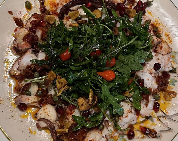 Grilled octopus salad with arugula and pomegranate