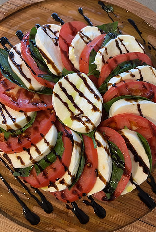 Caprese salad with fresh mozzarella, tomatoes and balsamic glaze